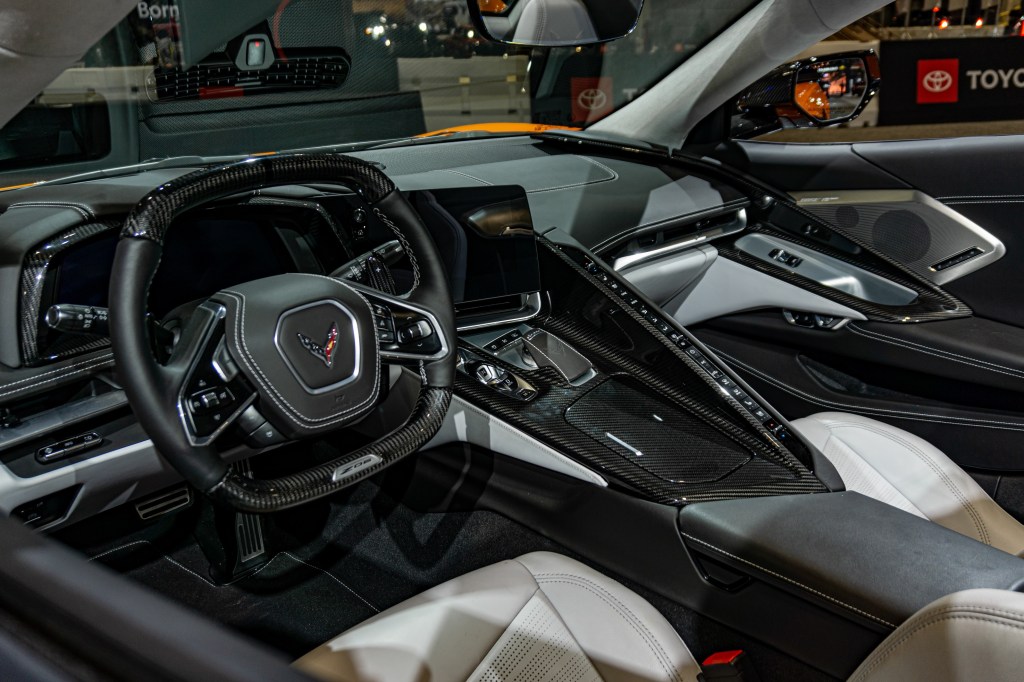 The carbon-fiber-trimmed white-leather interior of an orange 2023 C8 Chevrolet Corvette Z06 Convertible with Z07 Package at the Chicago Auto Show
