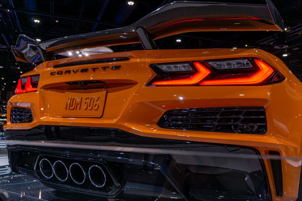An orange 2023 C8 Chevrolet Corvette Z06 Convertible with Z07 Package's carbon-fiber rear wing and quad exhaust tips at the Chicago Auto Show