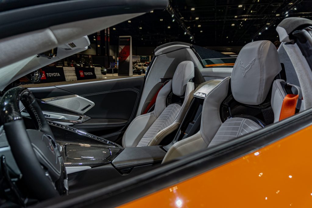 The white-leather sport seats in an orange 2023 C8 Chevrolet Corvette Z06 Convertible with Z07 Package at the Chicago Auto Show