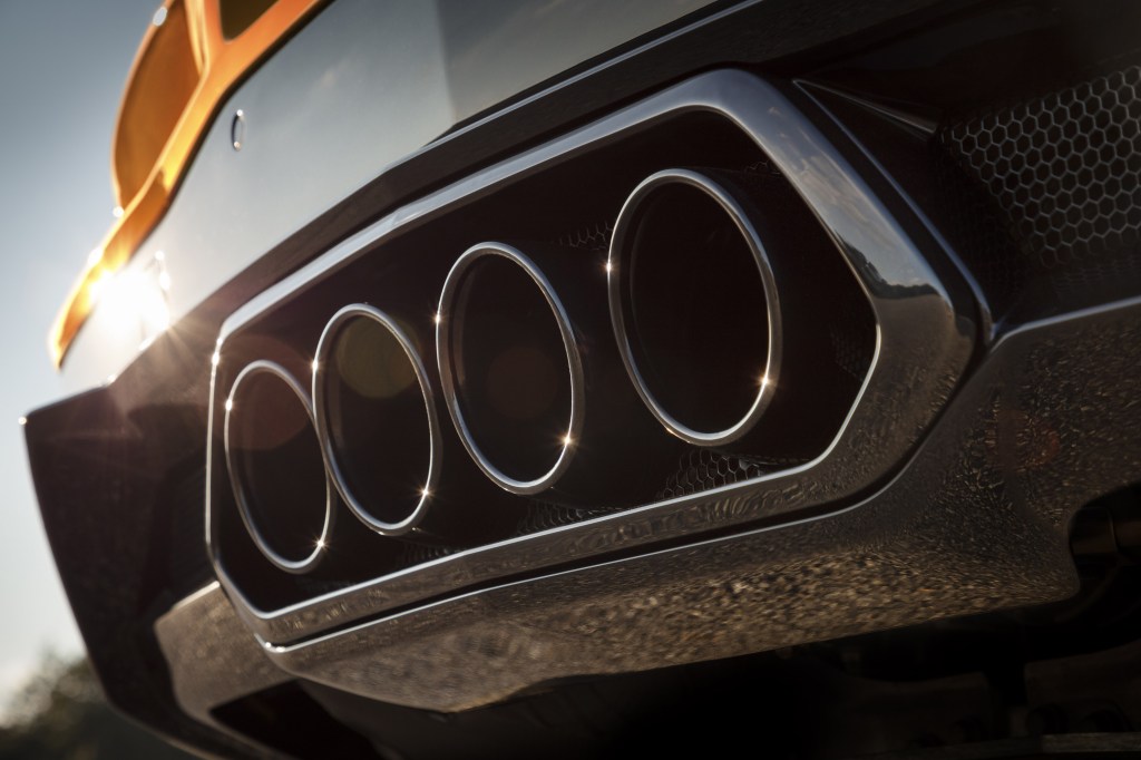 The quad exhaust tips of an orange 2023 C8 Chevrolet Corvette Z06