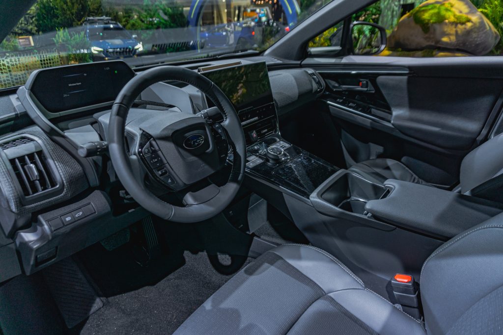 The gray-and-black front seats and dashboard of a 2023 Subaru Solterra at the 2022 Chicago Auto Show