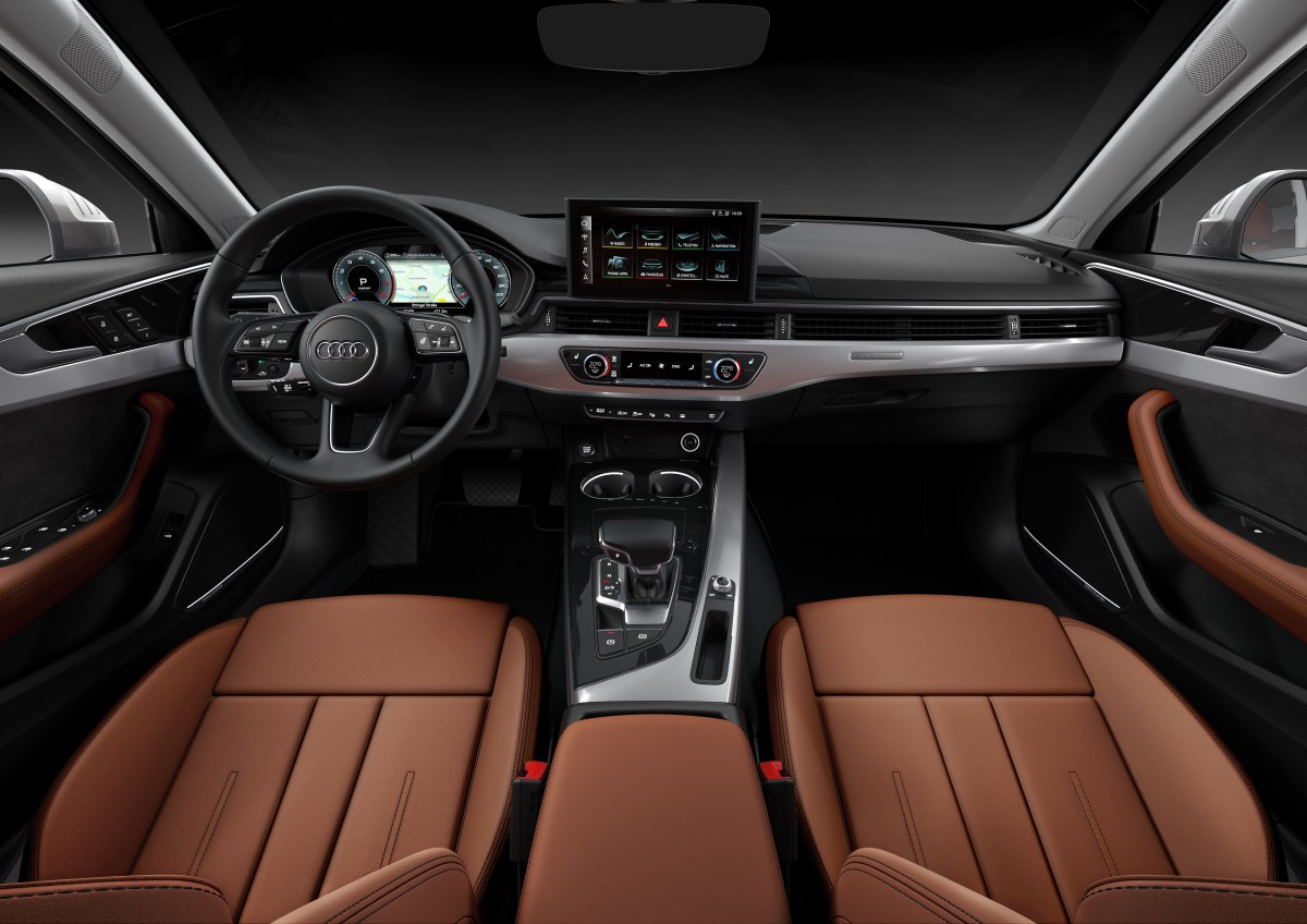 An interior view of an Audi A4 sedan cabin showing the steering wheel, dashboard, and infotainment system