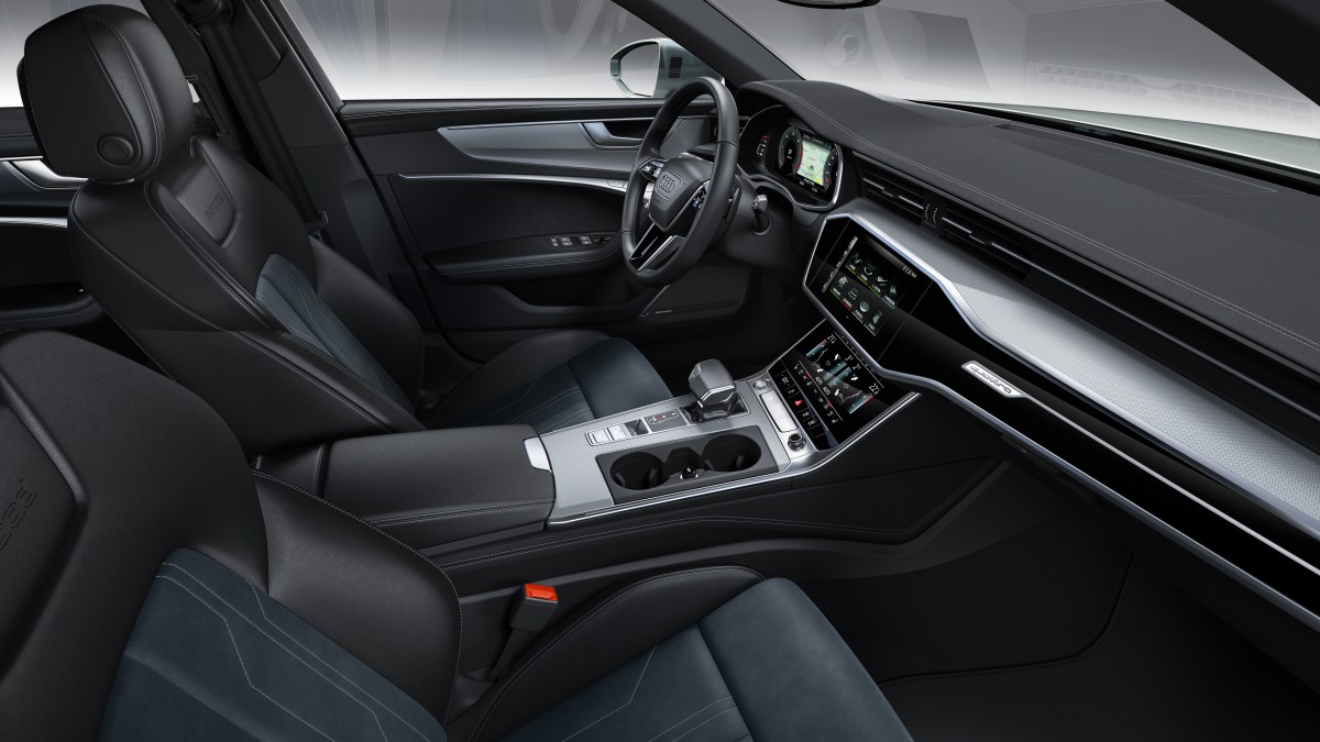 A view of the interior of a 2022 Audi A6 showing the driver and passenger seats, steering wheel, gauges, and infotainment displays.