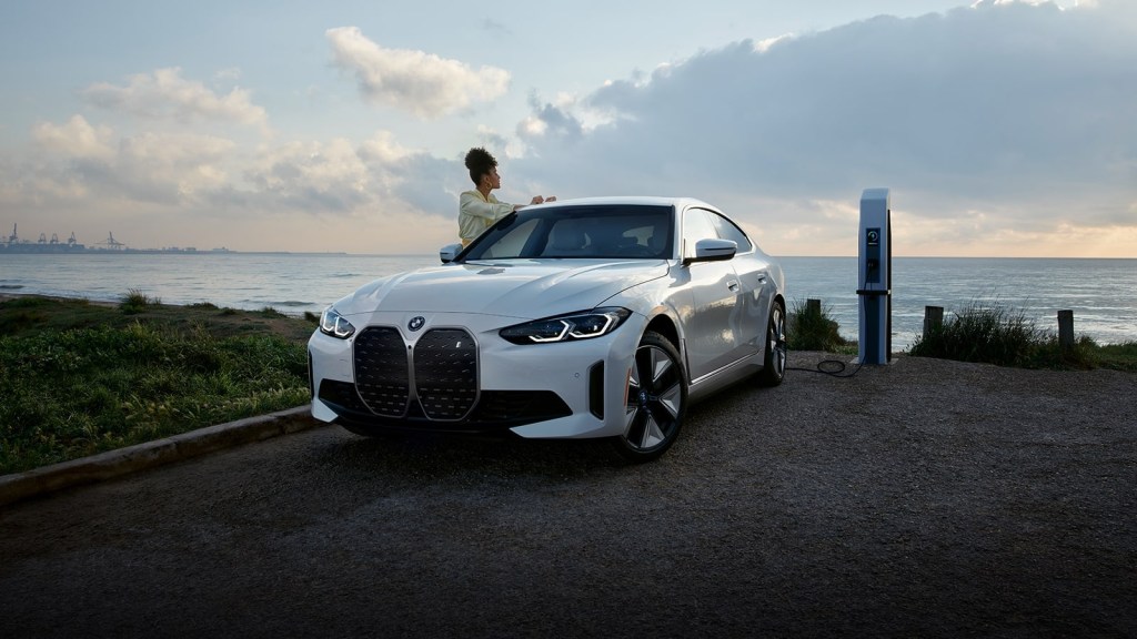 Alpine White 2022 BMW i4 charging at an EV charging station
