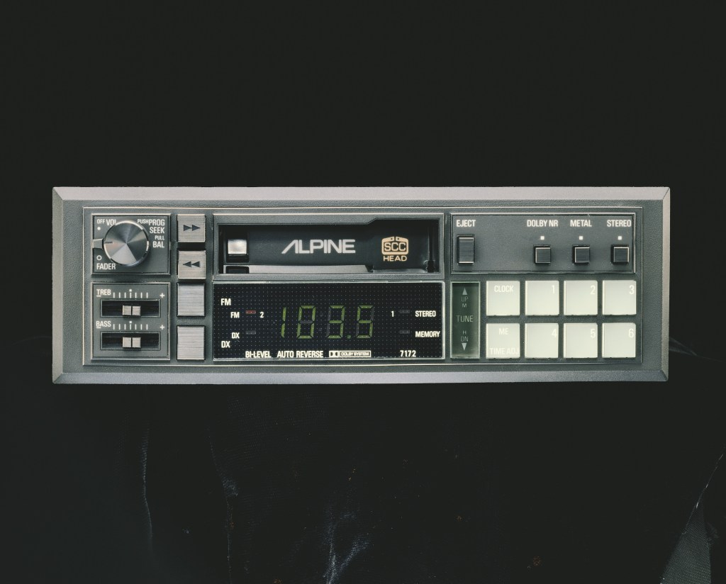 An old Alpine cassette deck against a black background