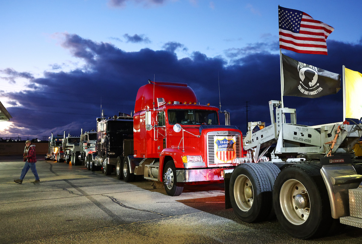 Truckers and supporters gather before departing for Washington, D.C., to protest COVID-19 mandates on February 22, 2022
