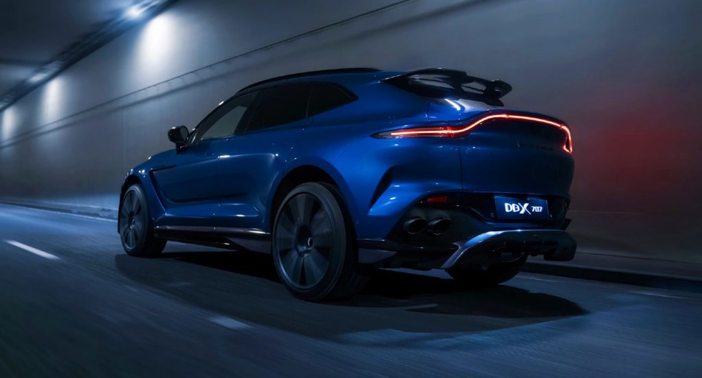 A blue Aston Martin DBX707 is on display.