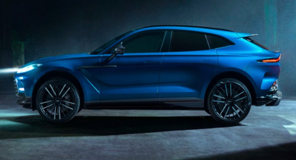 A blue Aston Martin DBX707 is on display.