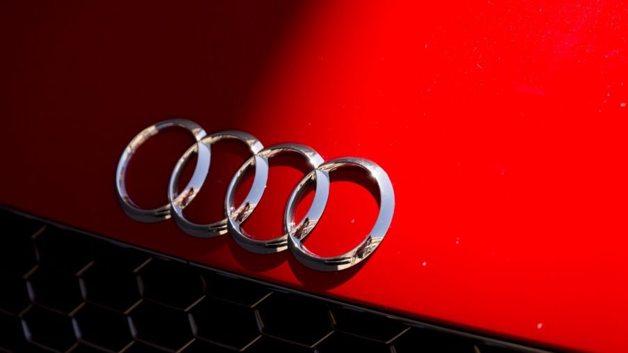 Audi's four rings logo on the hood of one of its cars