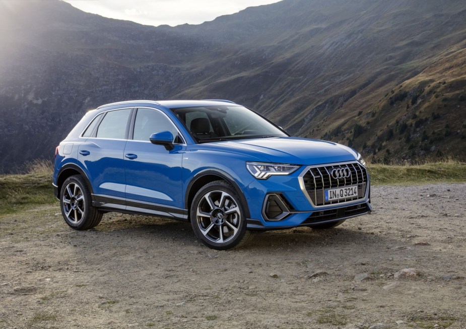 A blue 2022 Audi Q3 parked in a mountainous outdoor environment.