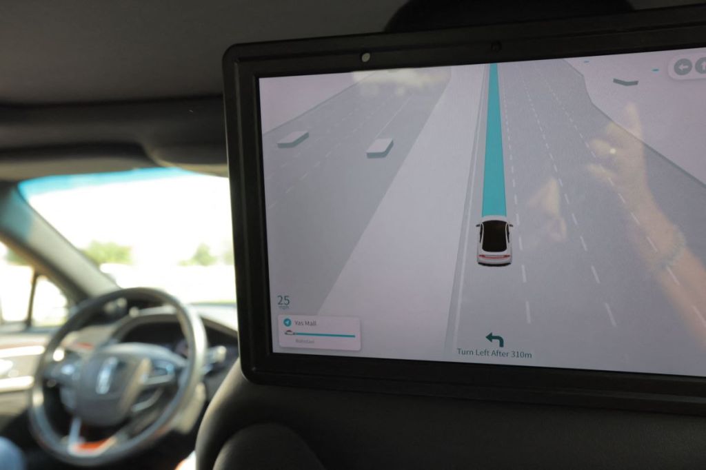 A screen in a potentially self-driving / autonomous vehicle from the backseat. 