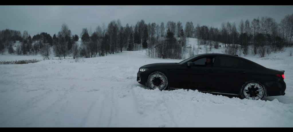 BMW M5 Competition parked in a snowy field awaiting its demise
