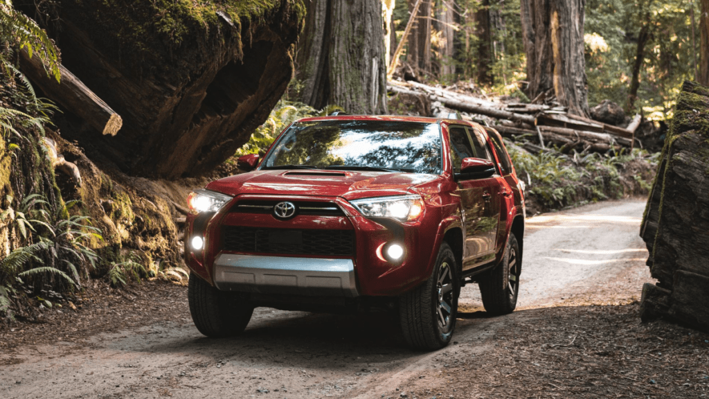 Barcelona Red Metallic 2022 Toyota 4Runner driving through a forest