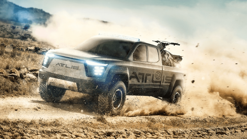 Black and grey Atlis XT, which could be the best electric pickup truck, driving on a dirt road