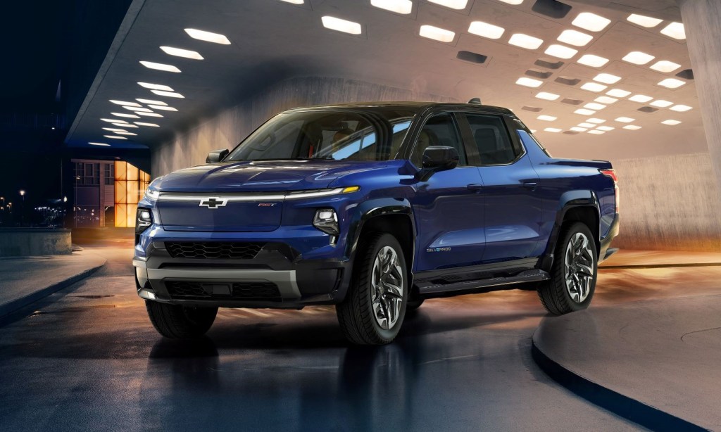 Blue 2024 Chevy Silverado EV, which could be the best electric pickup truck, driving out of parking garage