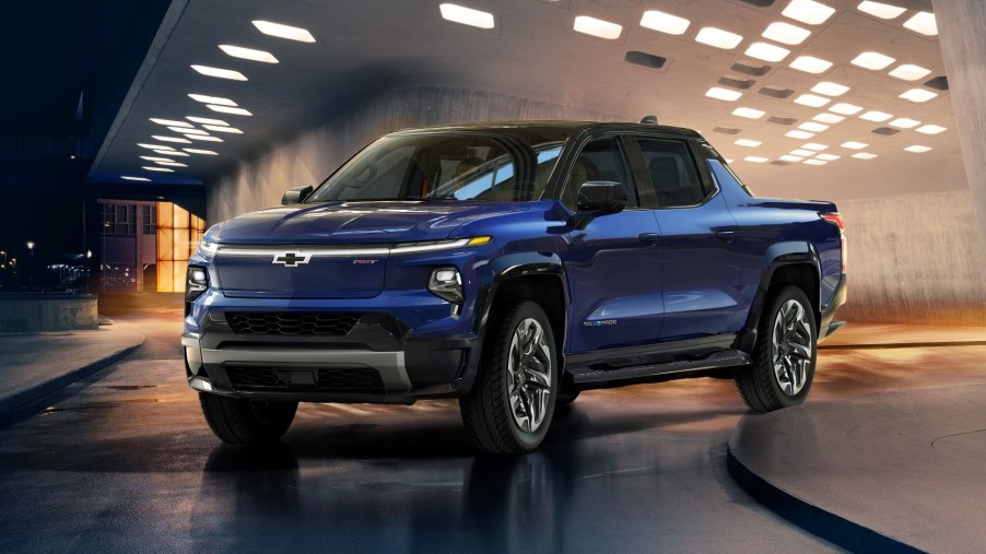 Blue 2024 Chevy Silverado EV, which could be the best electric pickup truck, driving out of parking garage