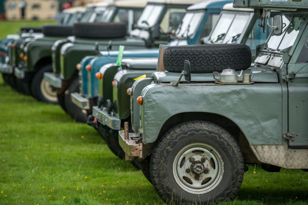 A group of 4x4 British SUVs in a row.