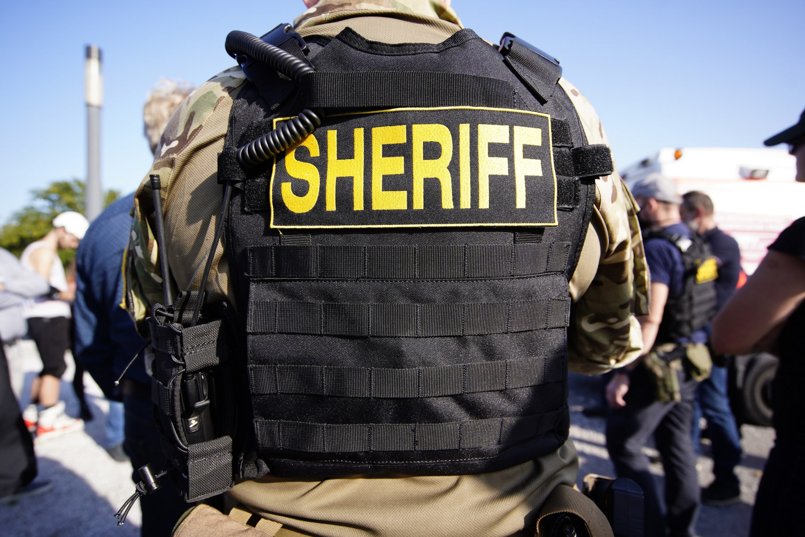 The back of a bulletproof vest that reads "sheriff"