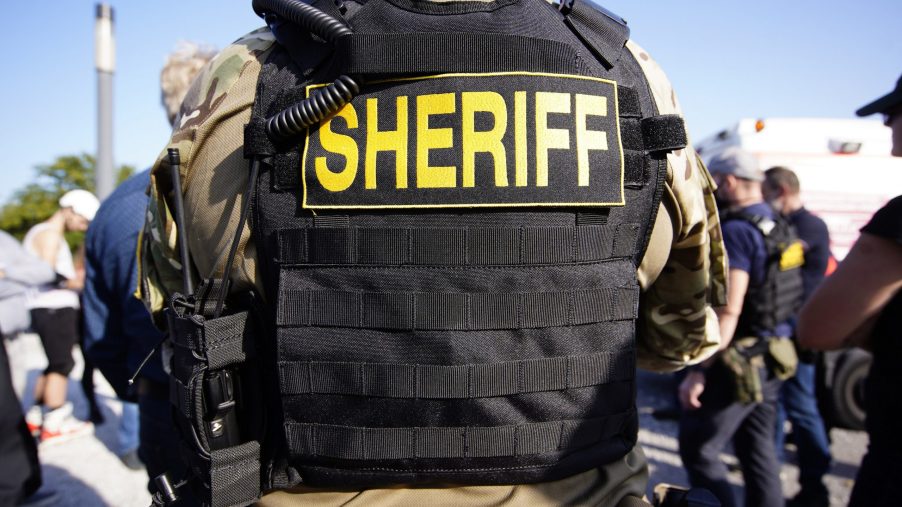The back of a bulletproof vest that reads "sheriff"