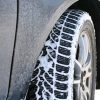 A car tire with snow between the treads
