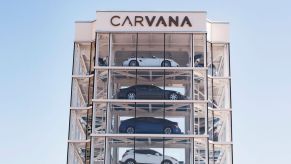 Multistory Carvana building with multiple cars on display.