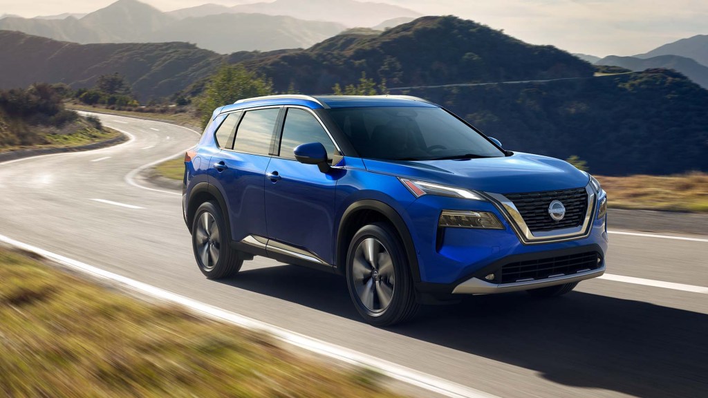Caspian Blue Metallic 2022 Nissan Rogue driving on a mountain road