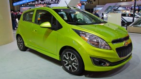 A green Chevy Spark small car is on display.