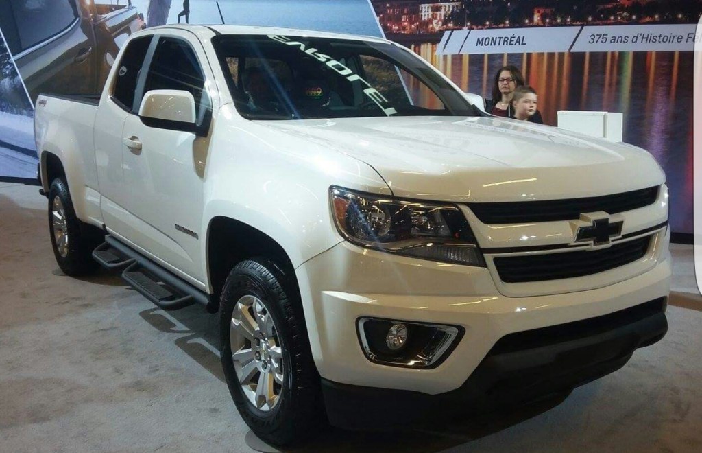 A Chevy Colorado mid-size truck is on display at an auto show.