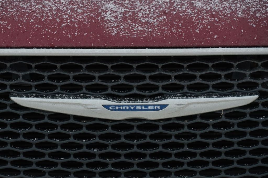 Chrysler logo on the front of a red Chrysler.