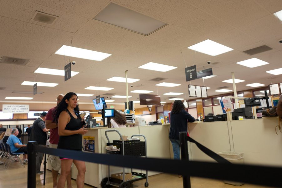 Customers wait in a DMV line