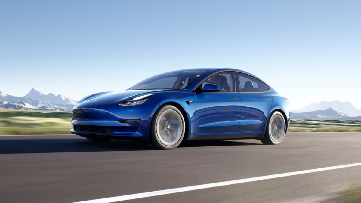 Deep Blue Metallic 2022 Tesla Model 3 with mountains in the background