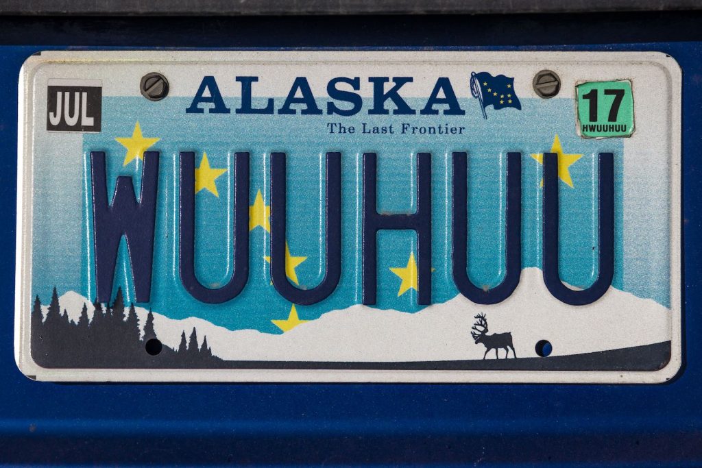 Alaskan vanity license plate on a blue car reads "WUUHUU"
