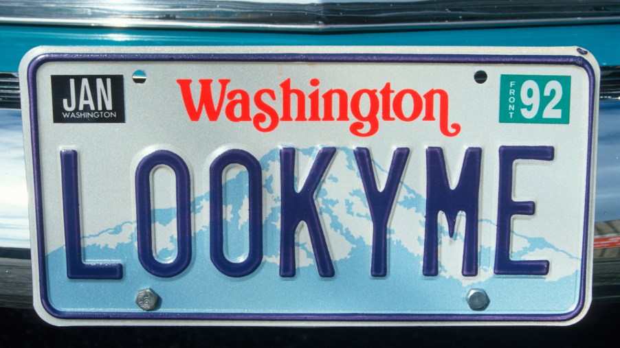 A blue on white Washington state license plate personalized to say "LookyMe"