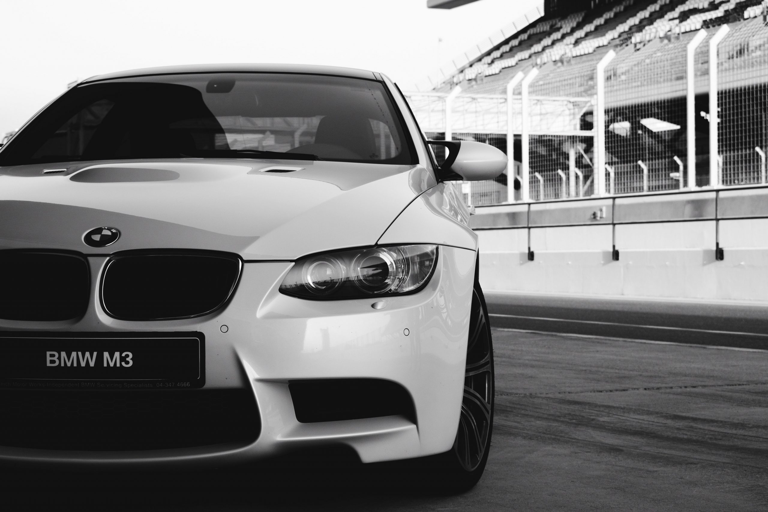 A white E92 BMW shot from the front headlights in black and white
