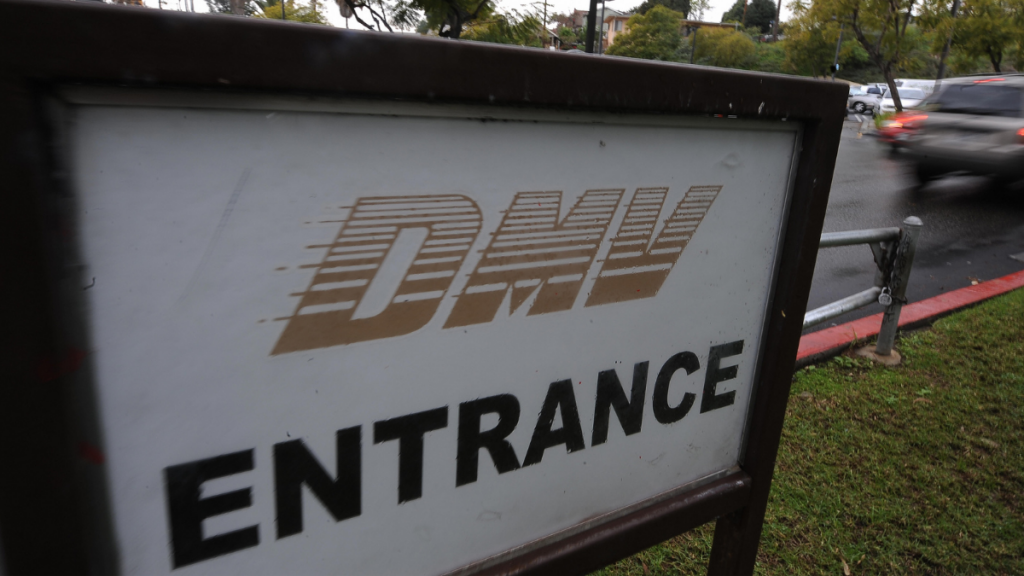 Entrance sign for a Department of Motor Vehicles DMV building, highlighting DMV smishing scam