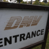Entrance sign for a Department of Motor Vehicles DMV building, highlighting DMV smishing scam
