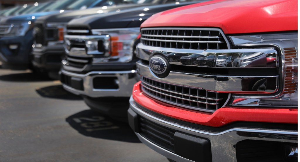 Ford F-150 models are parked on the lot. 