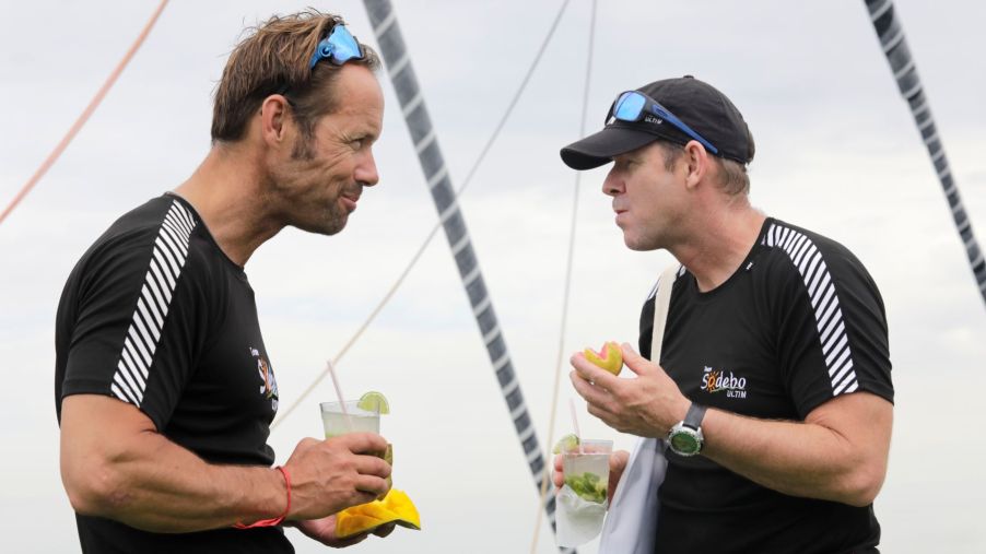 French yacht racers Thomas Coville and Jean-Luc Nelias celebrating with alcoholic drinks after winning a race in Salvador, Brazil