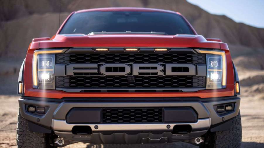 Front view of orange 2022 Ford F-150 Raptor, highlighting release date of F-150 Raptor R