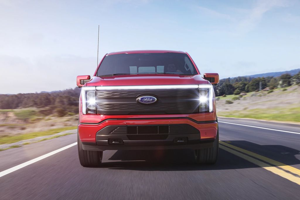 Front view of red 2022 Ford F-150 Lightning, highlighting electric road in Detroit