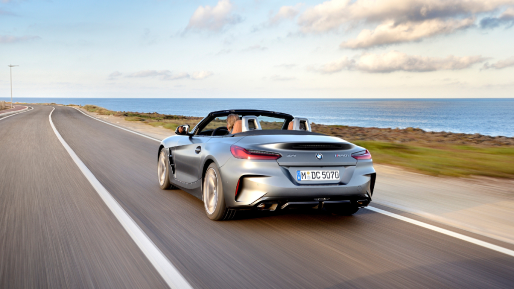 Fully loaded new silver 2022 BMW Z4 M40i roadster convertible driving on a coastal road