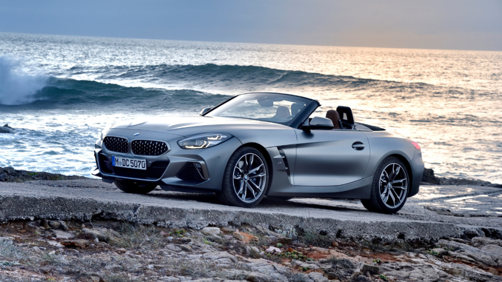 Fully loaded new silver 2022 BMW Z4 M40i roadster convertible parked next to the ocean
