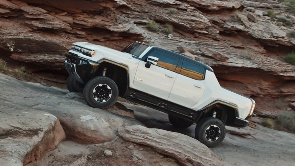 The 2022 GMC Hummer EV climbing up rocks 
