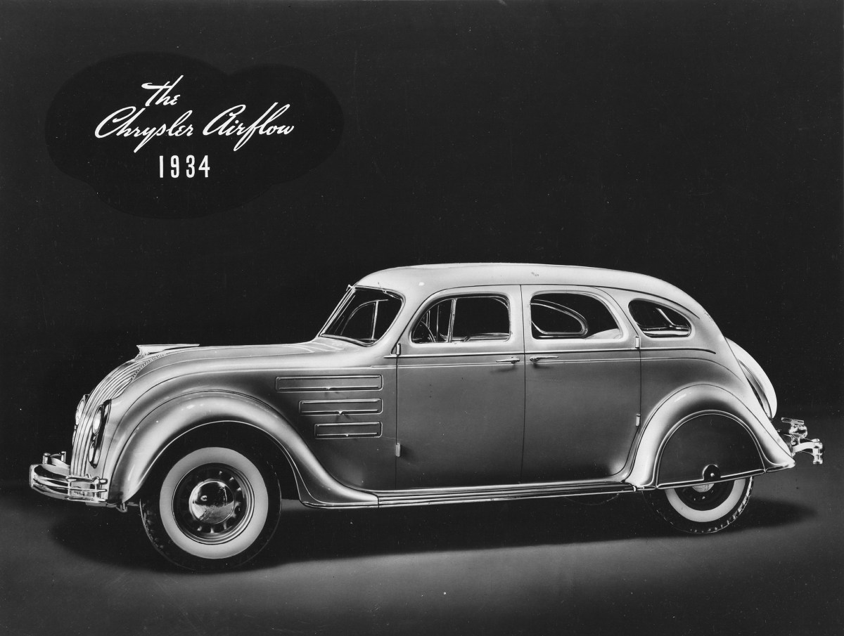 A black and white promotional photo of a 1934 Chrysler Airflow sedan.