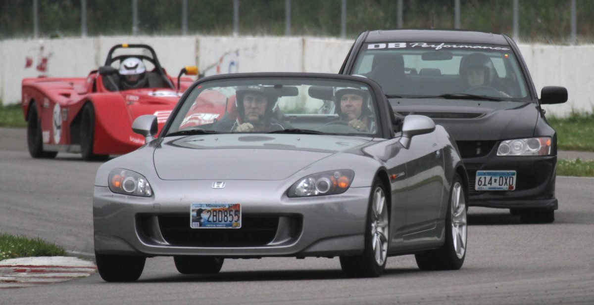 A Honda S2000, Mitsubishi and spec Ford racers laped the track during the Brainerd International Raceway Performance Driving School