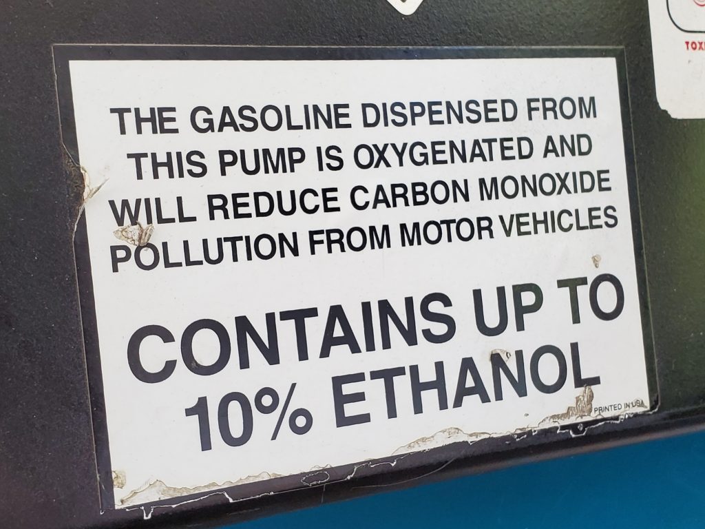 Close-up of a notice on gas pump stating that the dispensed fuel contains up to 10% ethanol.