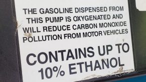 Close-up of a notice on gas pump stating that the dispensed fuel contains up to 10% ethanol.