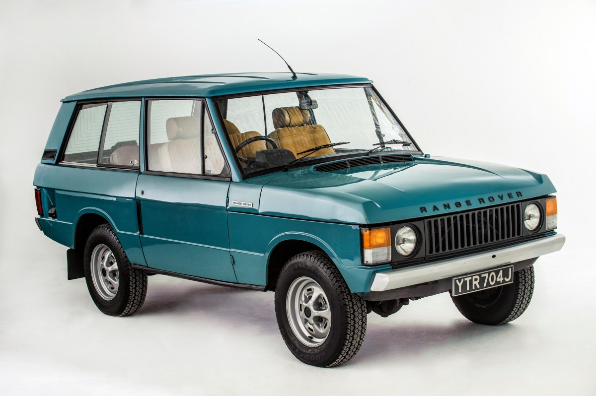 A 3/4 front view of a teal 1971 Land Rover Range Rover with a white studio background