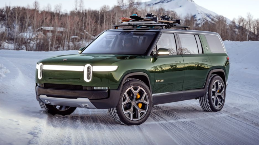 Green 2022 Rivian R1S parked on a snowy road, highlighting how it's the best electric SUV