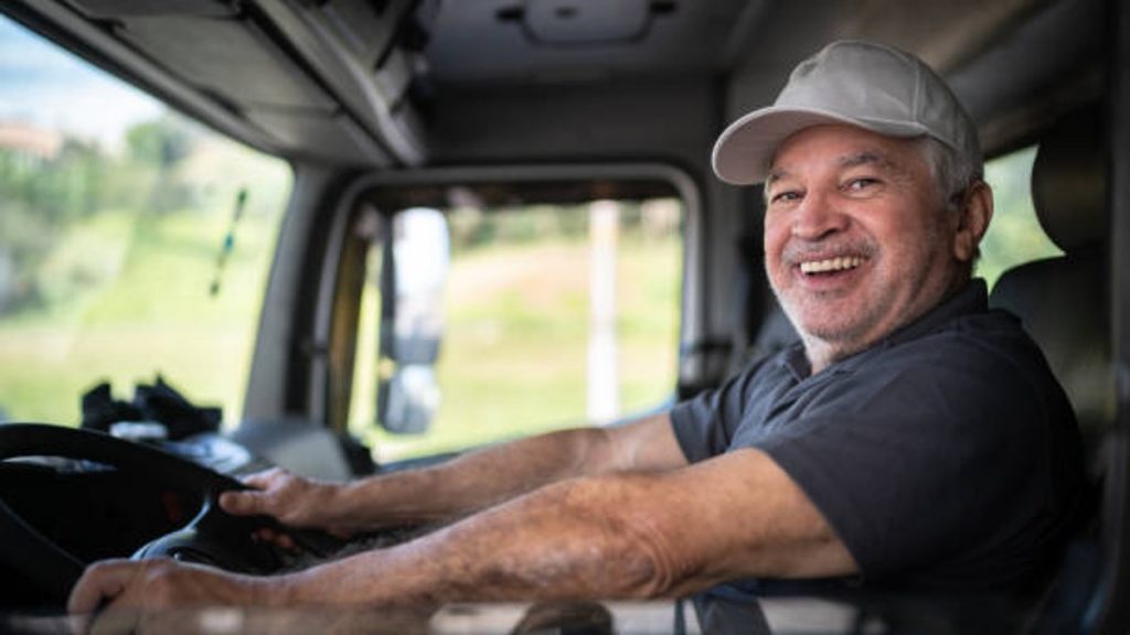 Happy truck driver in the cab
